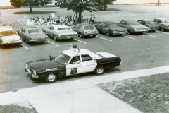 believed to possibly be a 1973 Plymouth Fury police car in front of then Applegarth Middle School The building is now Applegarth Elementary School