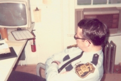 An officer sitting in the Dispatch Room in 1974 at the Police Station Located on Spotswood Englishtown Road